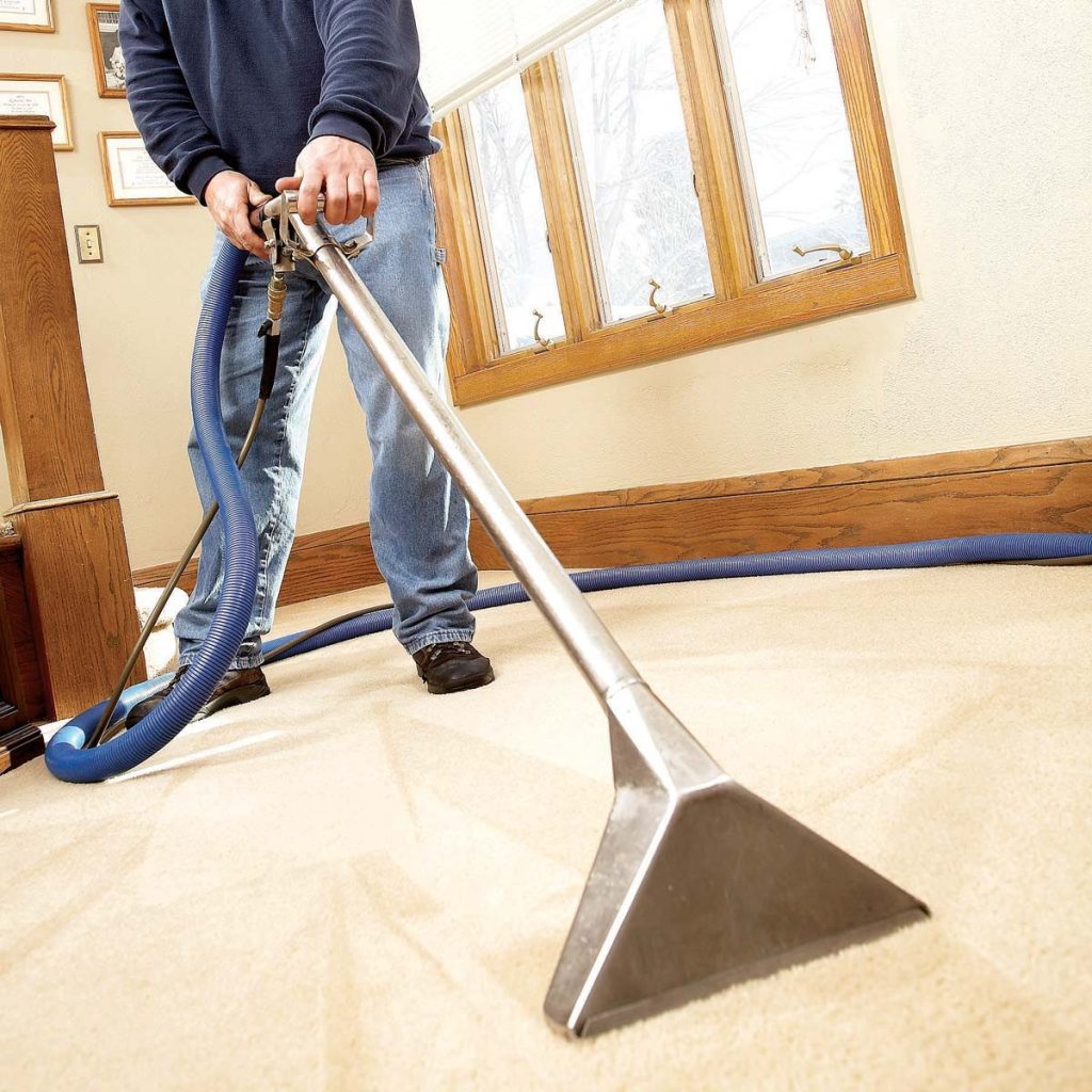 man professionally cleaning carpet