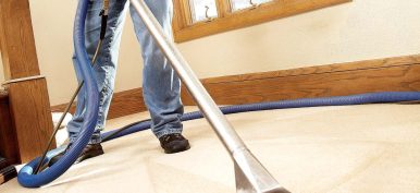 man professionally cleaning carpet